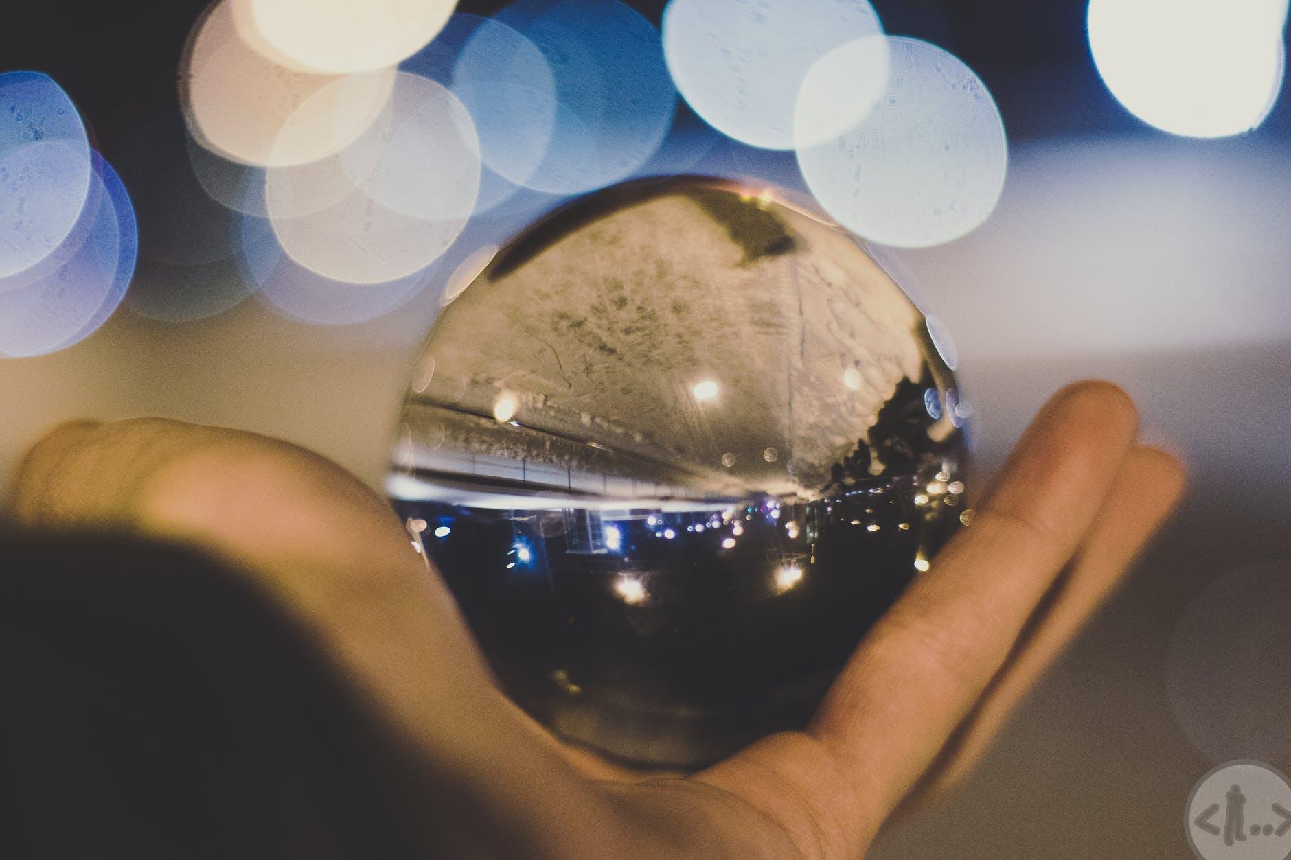 crystal ball on person s hand