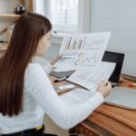 woman analyzing the design business progress reports