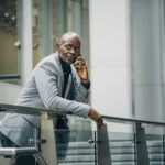 serious african american entrepreneur talking on phone on street