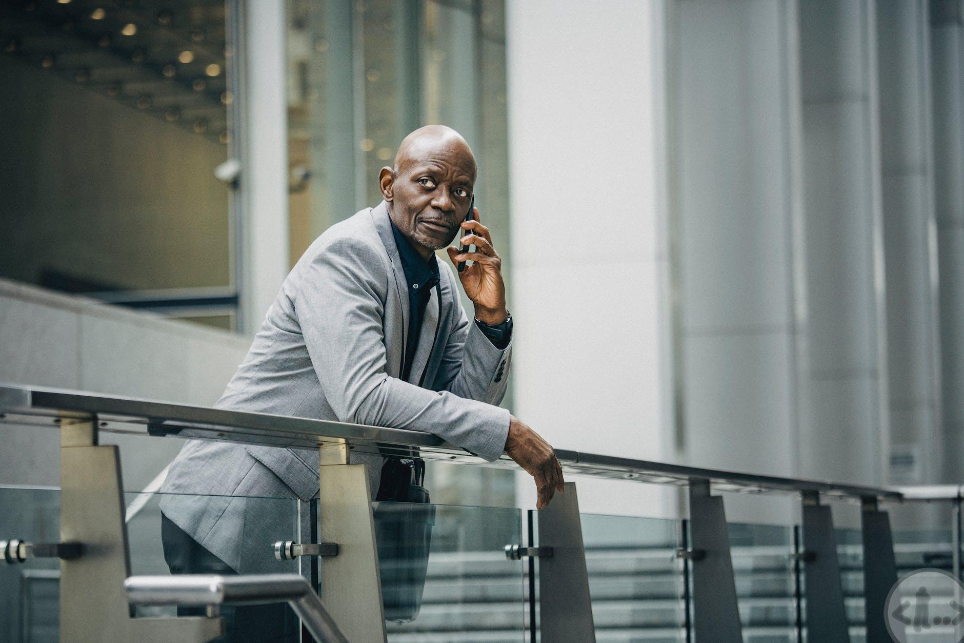 serious african american entrepreneur talking on phone on street