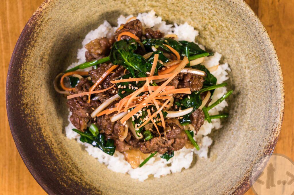 close up photo of scrumptious meat dish topped on rice