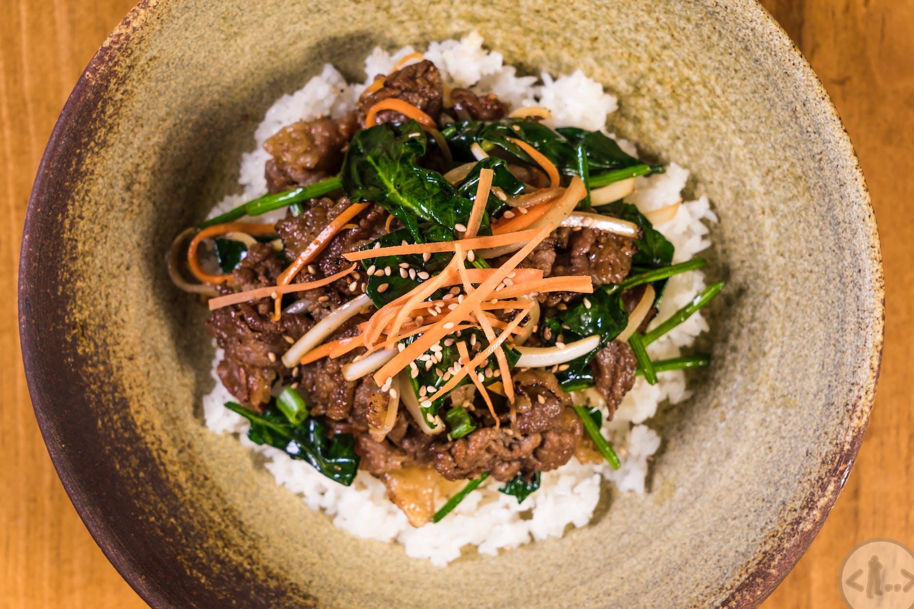 close up photo of scrumptious meat dish topped on rice